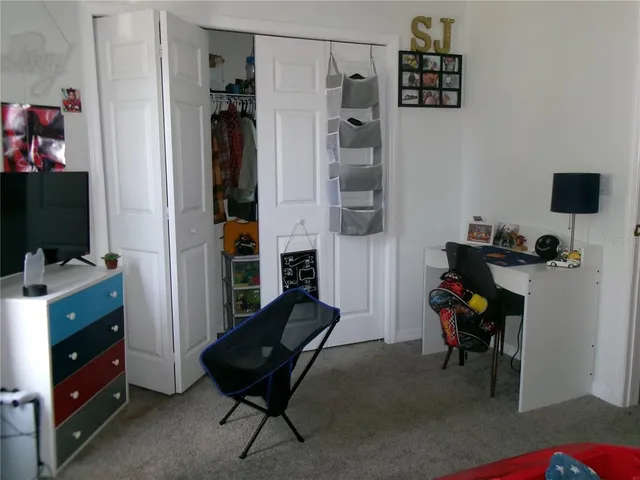 a bedroom with a bed and a television