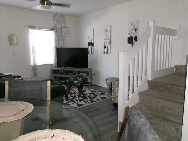 a view of a dining room with furniture and wooden floor