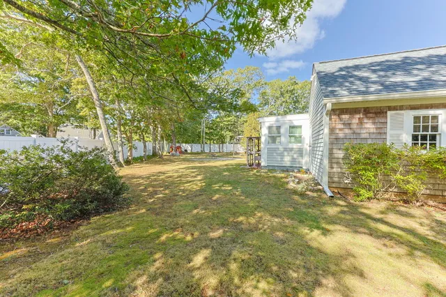 a view of a house with a yard and plants