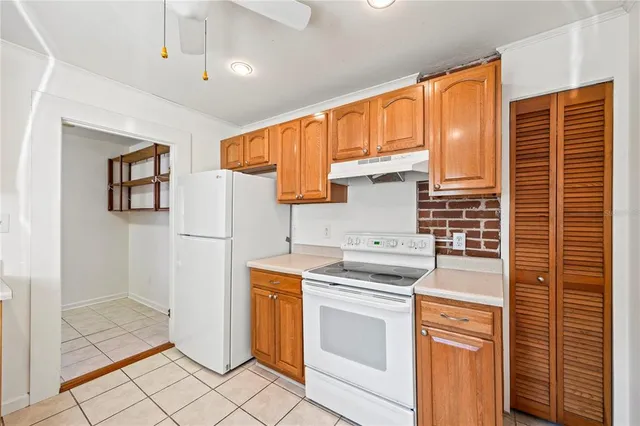 a kitchen with a stove a sink and a refrigerator