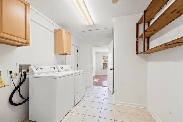 a utility room with cabinets and washer
