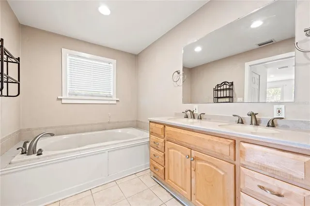 a bathroom with a granite countertop tub sink double vanity granite and a window