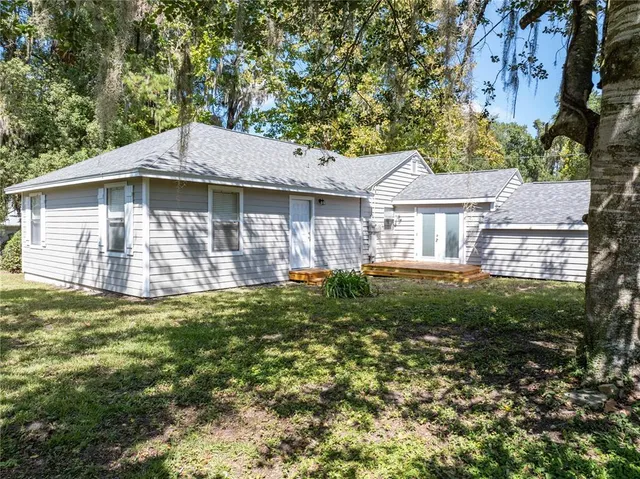 a backyard of a house with table and chairs