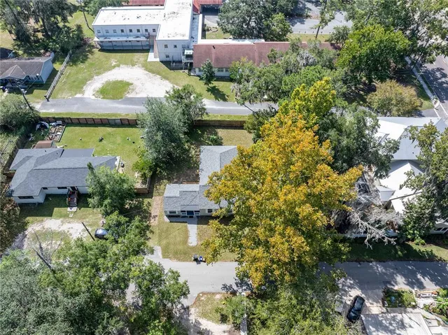 an aerial view of a house with a yard and garden