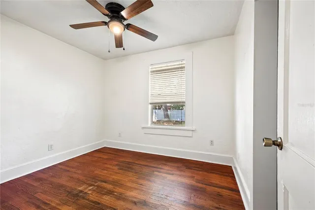 wooden floor in an empty room with a window