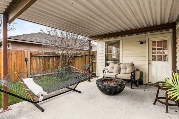 a view of a backyard with furniture and floor to ceiling window