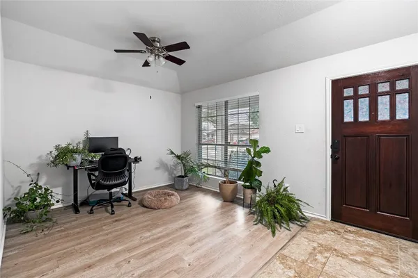 a living room with furniture and a potted plant