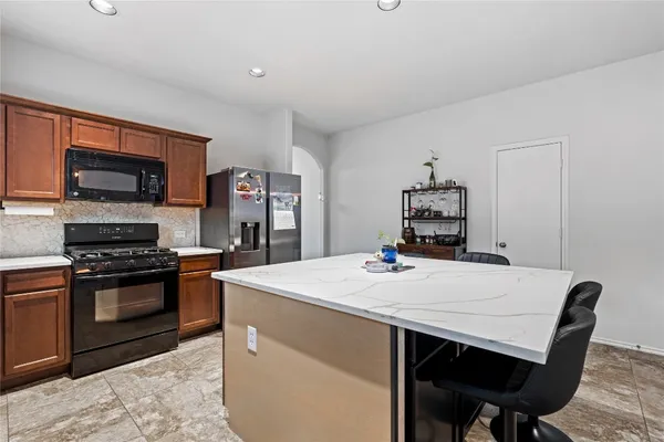 a kitchen with a stove a sink and a refrigerator