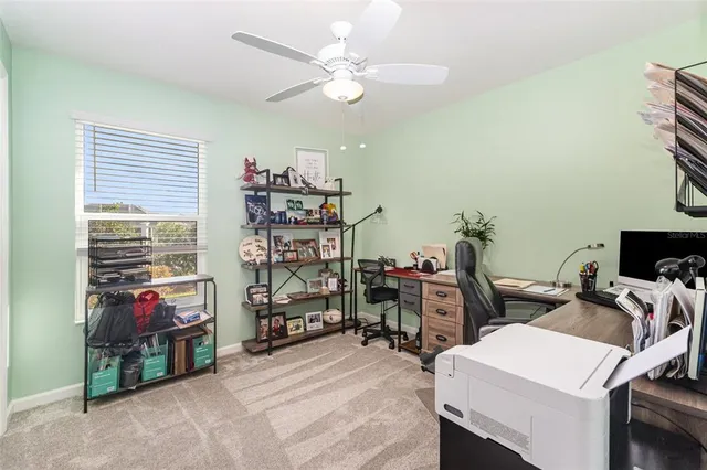 a view of a room with workspace and a window