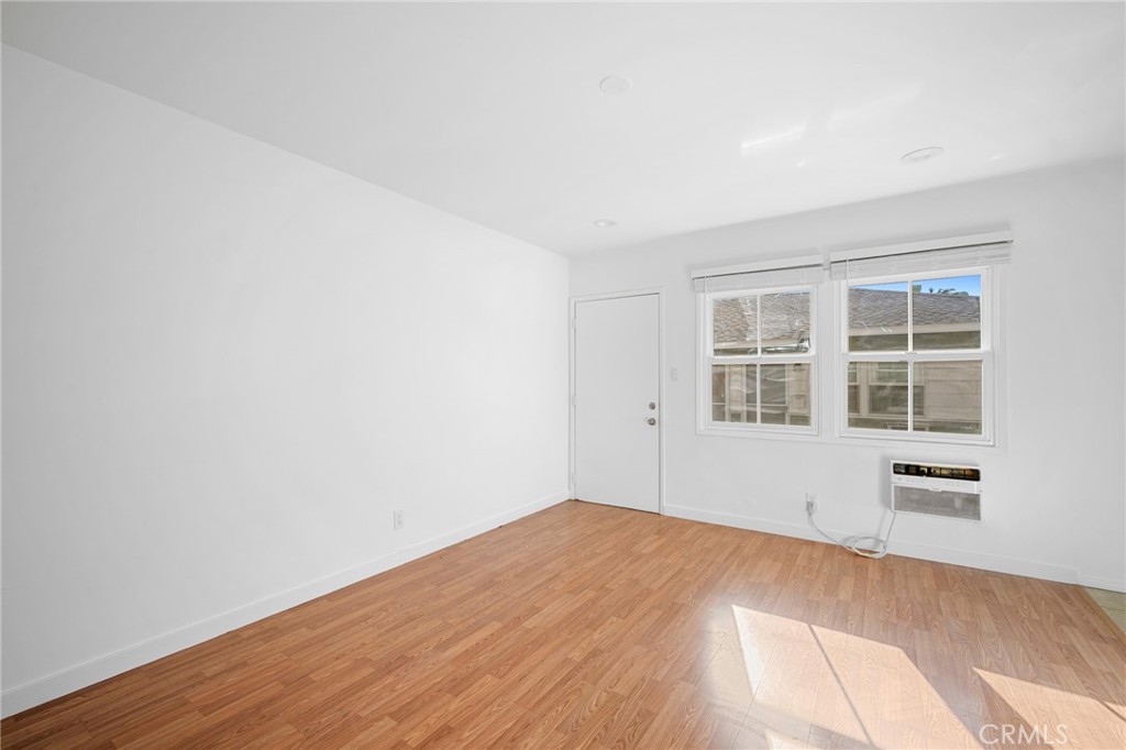 10230 Silverton Avenue, Unit 1 Tujunga, CA 91042 - Photo 5 of 26 a view of empty room with wooden floor and fan