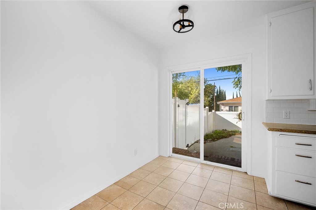 10230 Silverton Avenue, Unit 1 Tujunga, CA 91042 - Photo 7 of 26 a view of kitchen with furniture and floor to ceiling window
