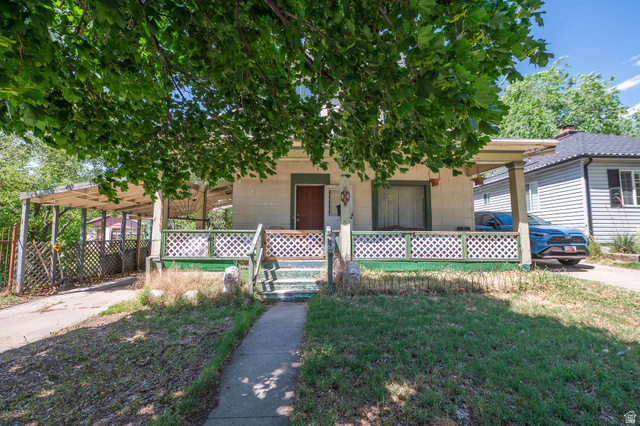 1256 24th Street Ogden, UT 84401 - Photo 2 of 34 Single-story residence featuring a covered front porch with lattice railing, a paved driveway, and a covered carport