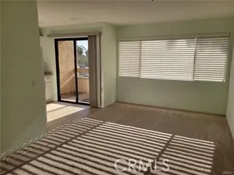 a view of a room with wooden floor and a window