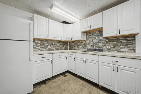 a kitchen with white cabinets
