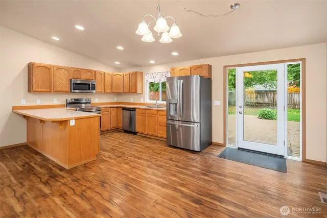 a kitchen with stainless steel appliances granite countertop a sink and a microwave