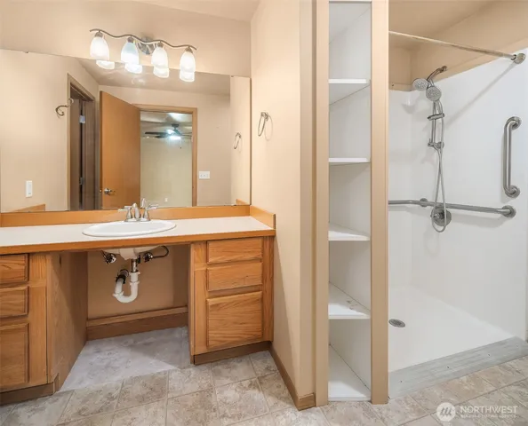 a view of walk in closet with empty racks