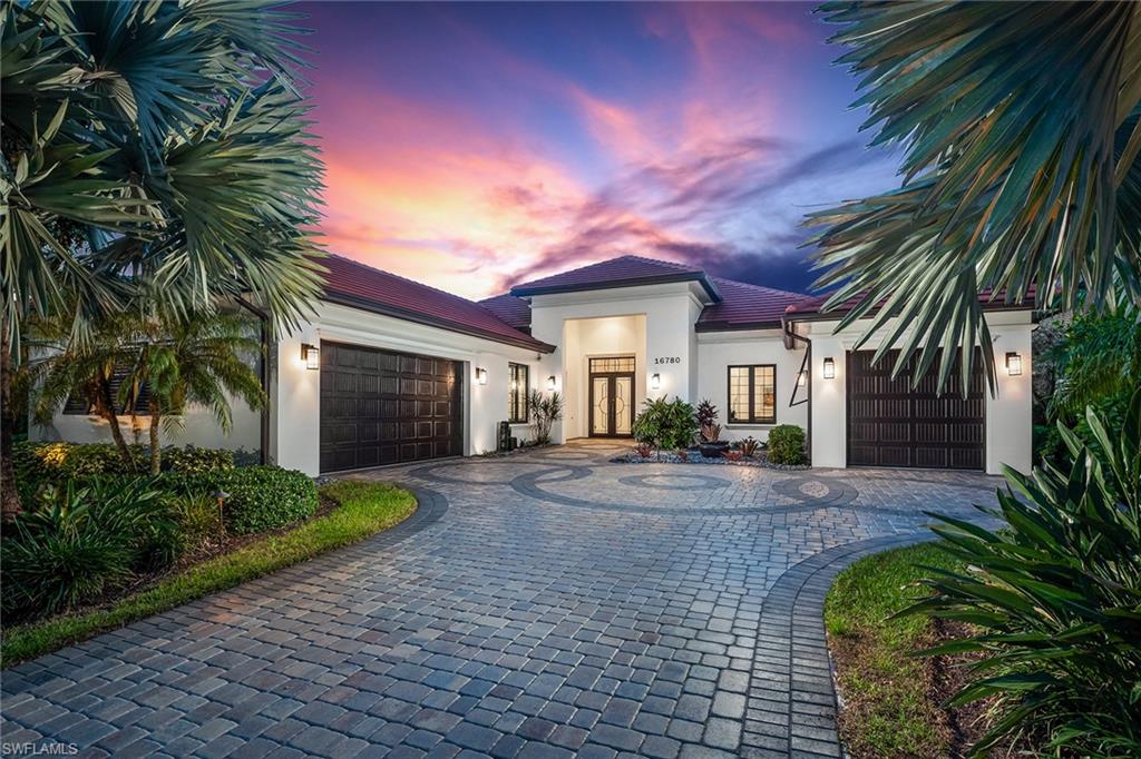front view of a house with a yard and potted plants