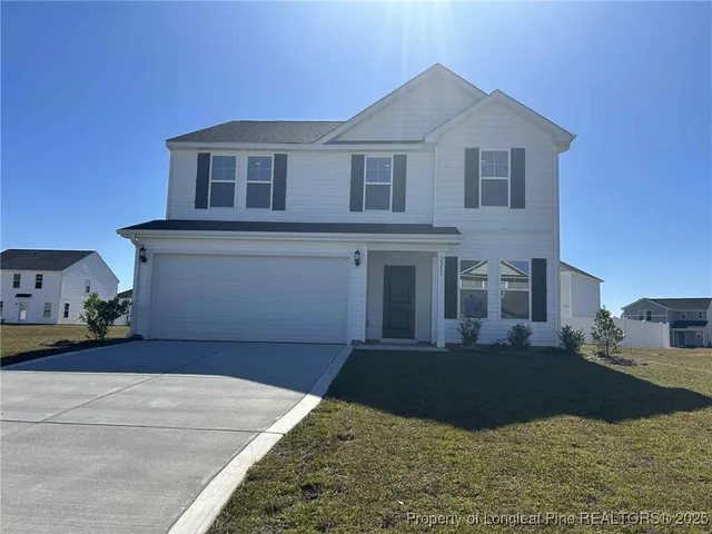a front view of a house with garage