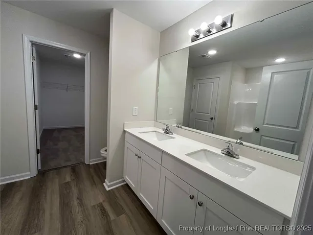 a bathroom with a double vanity sink and mirror