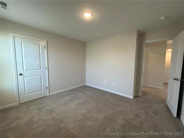 an empty room with closet area