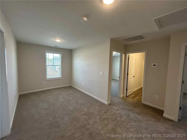 a view of an empty room and a window