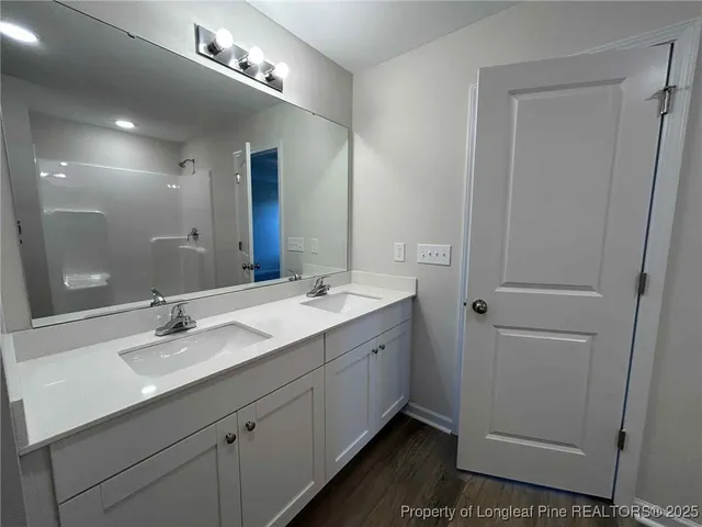 a bathroom with a double vanity sink and mirror