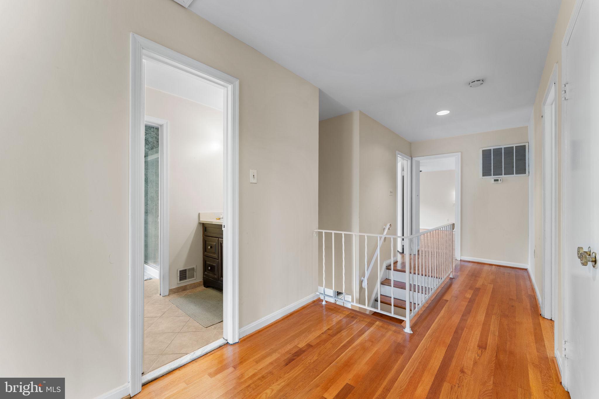 9 Snug Hill Court Potomac, MD 20854 - Photo 18 of 66 a view of a hallway with wooden floor and a bathroom