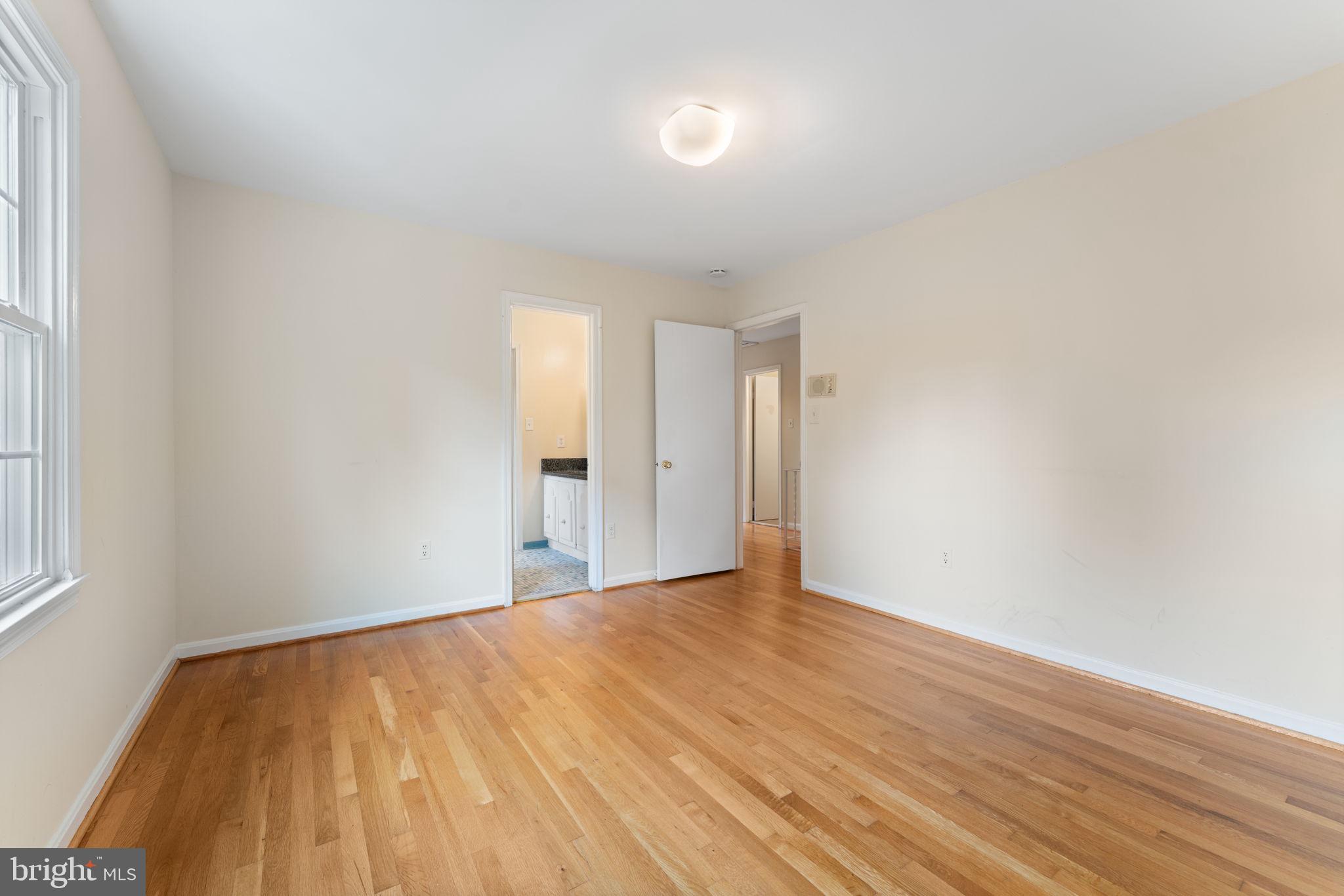 9 Snug Hill Court Potomac, MD 20854 - Photo 29 of 66 a view of an empty room with wooden floor and a window