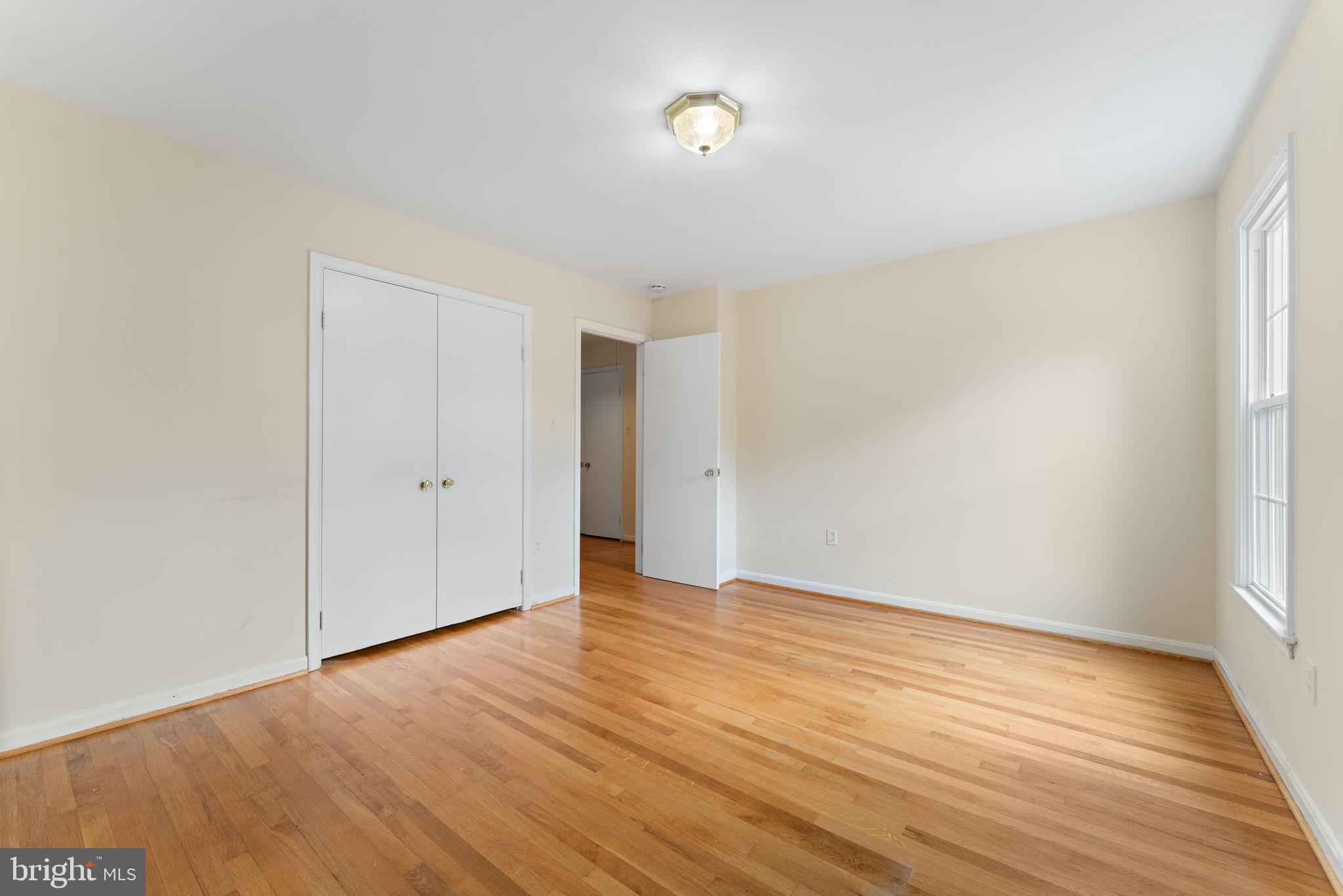 9 Snug Hill Court Potomac, MD 20854 - Photo 30 of 66 a view of an empty room with wooden floor and a window