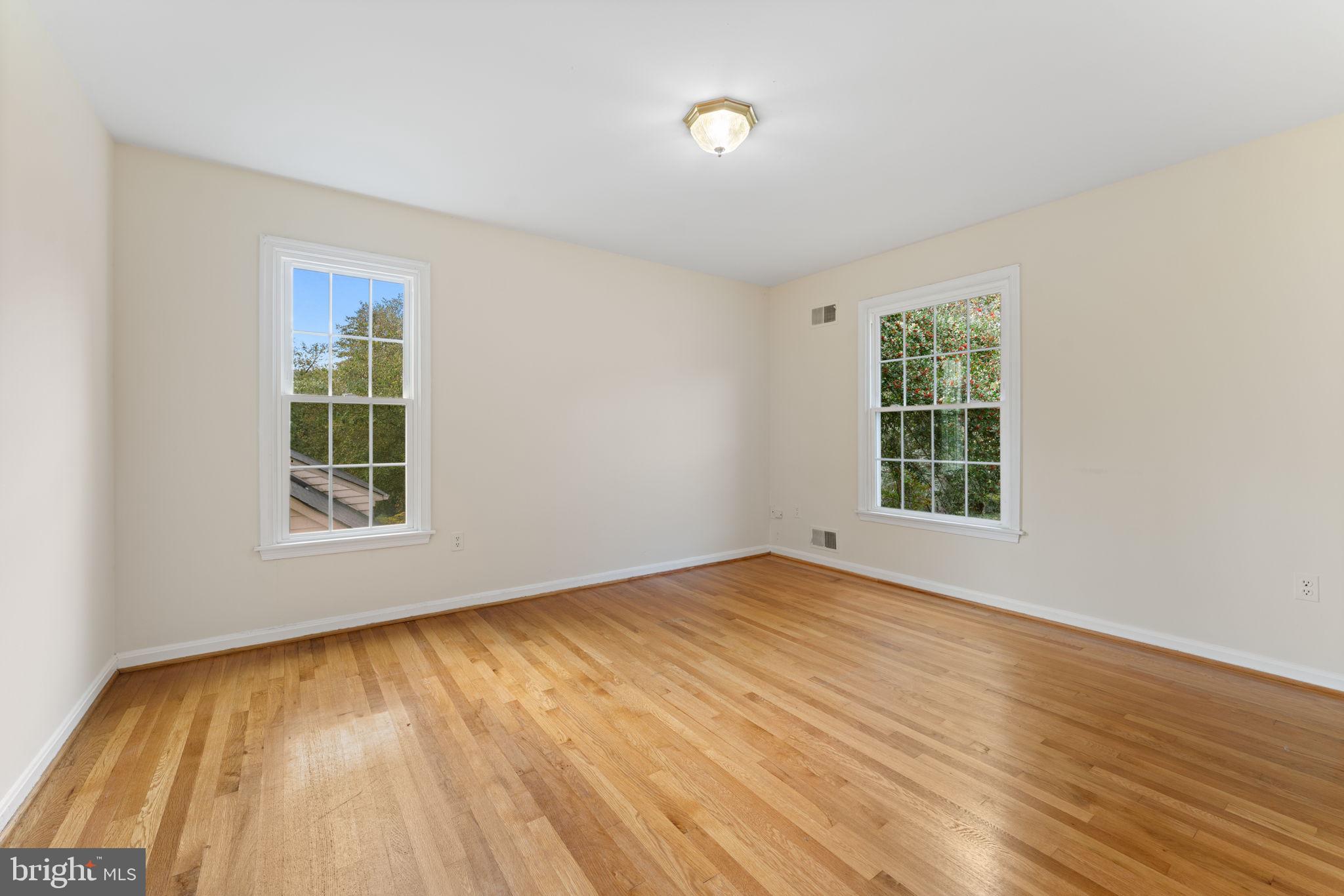 9 Snug Hill Court Potomac, MD 20854 - Photo 33 of 66 a view of an empty room with wooden floor and a window