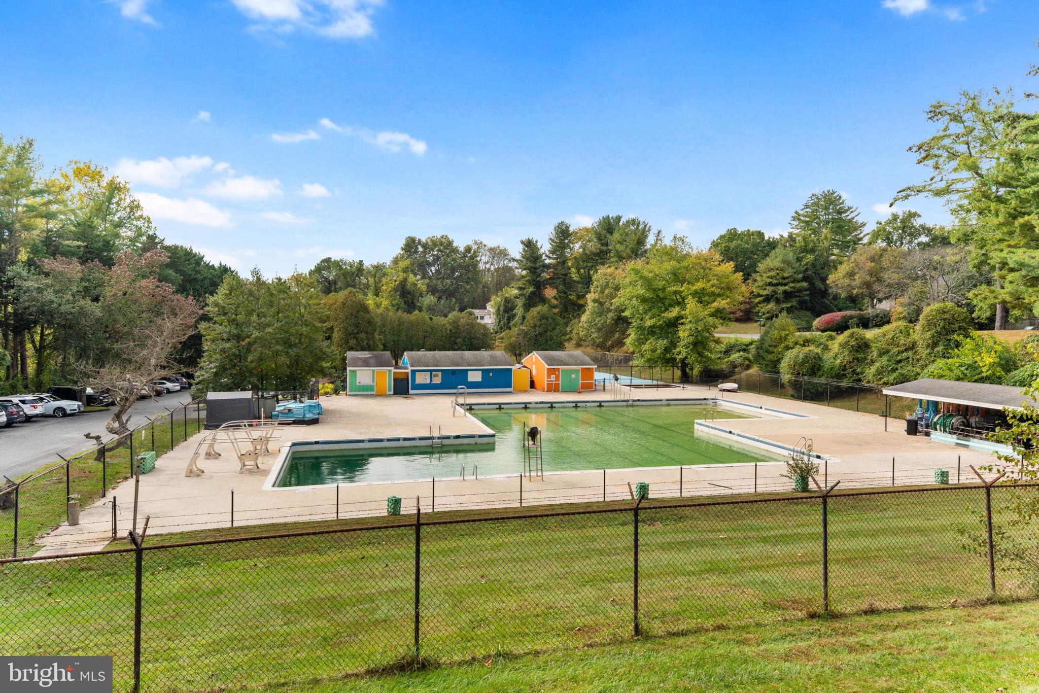 9 Snug Hill Court Potomac, MD 20854 - Photo 49 of 66 a view of a white house with a swimming pool