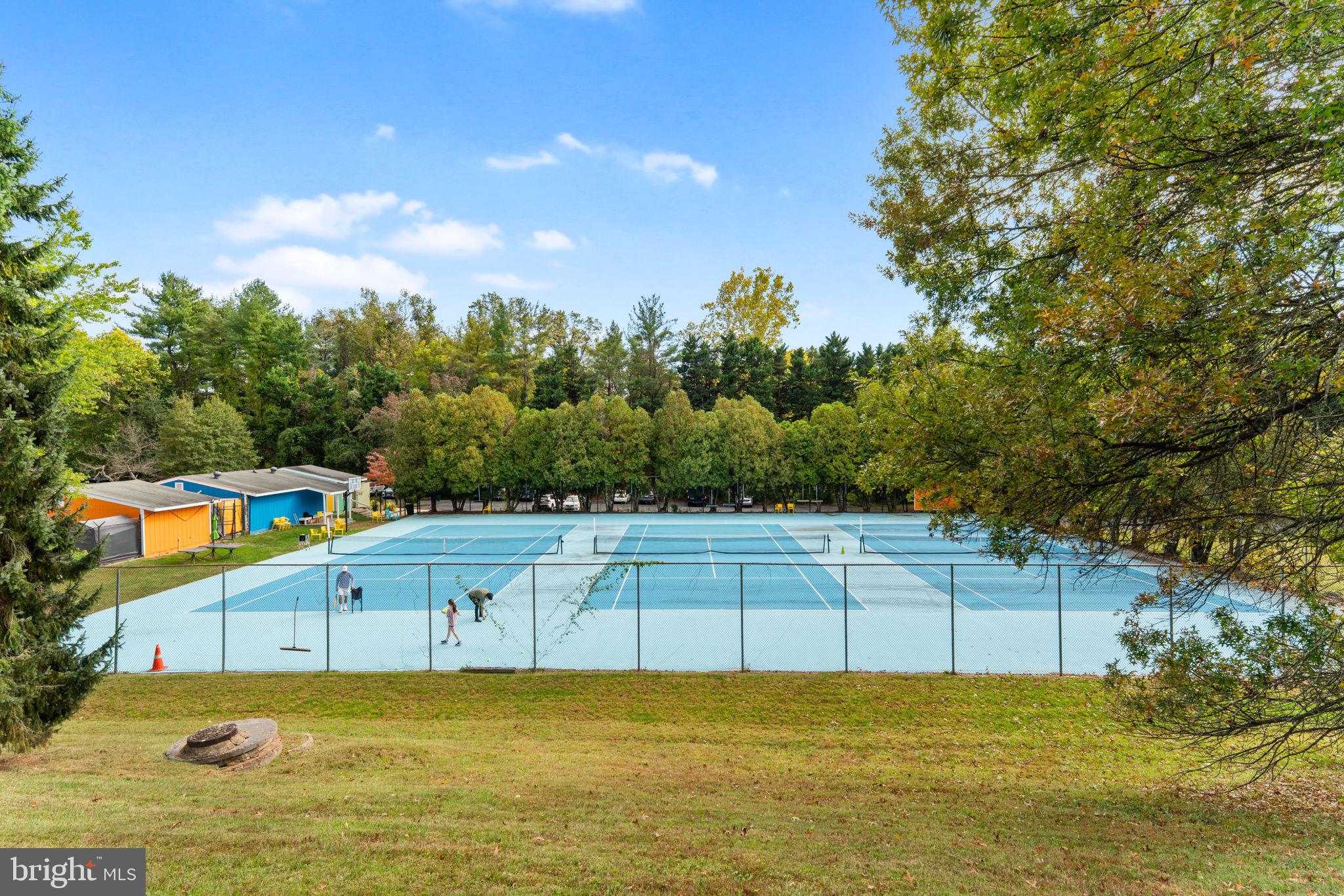 9 Snug Hill Court Potomac, MD 20854 - Photo 50 of 66 a view of a swimming pool with an outdoor seating and a yard