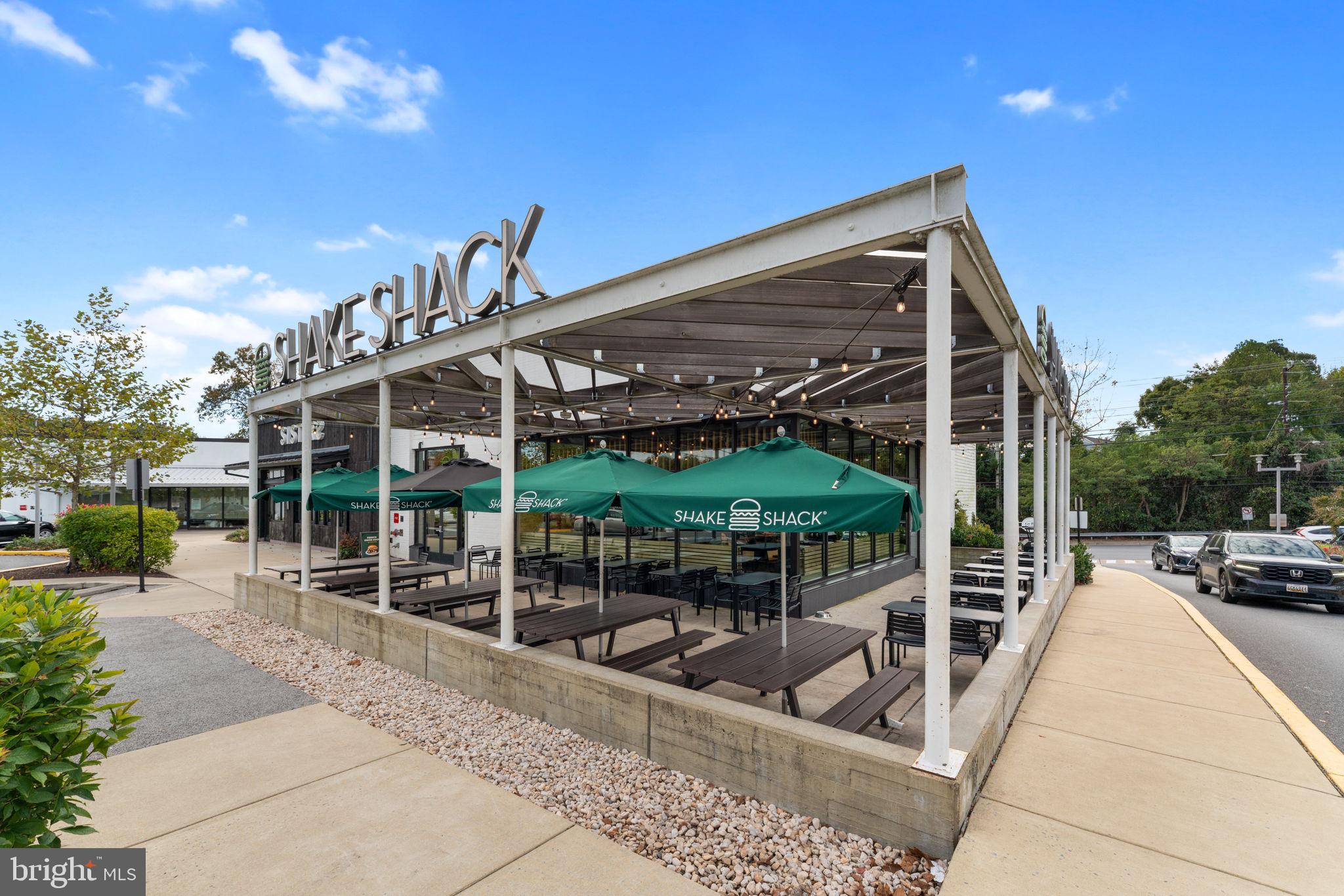 9 Snug Hill Court Potomac, MD 20854 - Photo 53 of 66 a view of a patio with couches table and chairs and potted plants