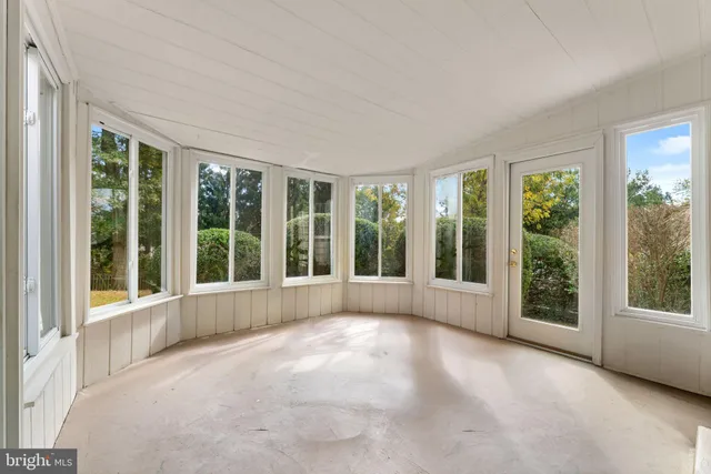 a view of an empty room with windows and yard