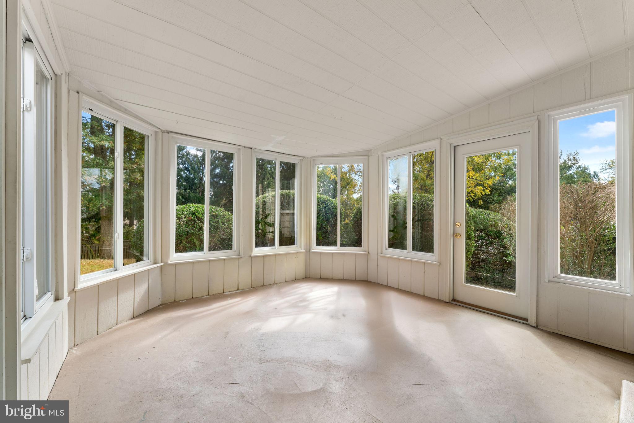 9 Snug Hill Court Potomac, MD 20854 - Photo 6 of 66 a view of an empty room with windows and yard