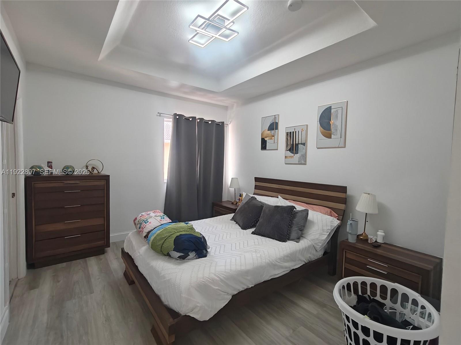 17847 Northwest 74th Path Hialeah, FL 33015 - Photo 24 of 35 a bedroom with a bed and dresser