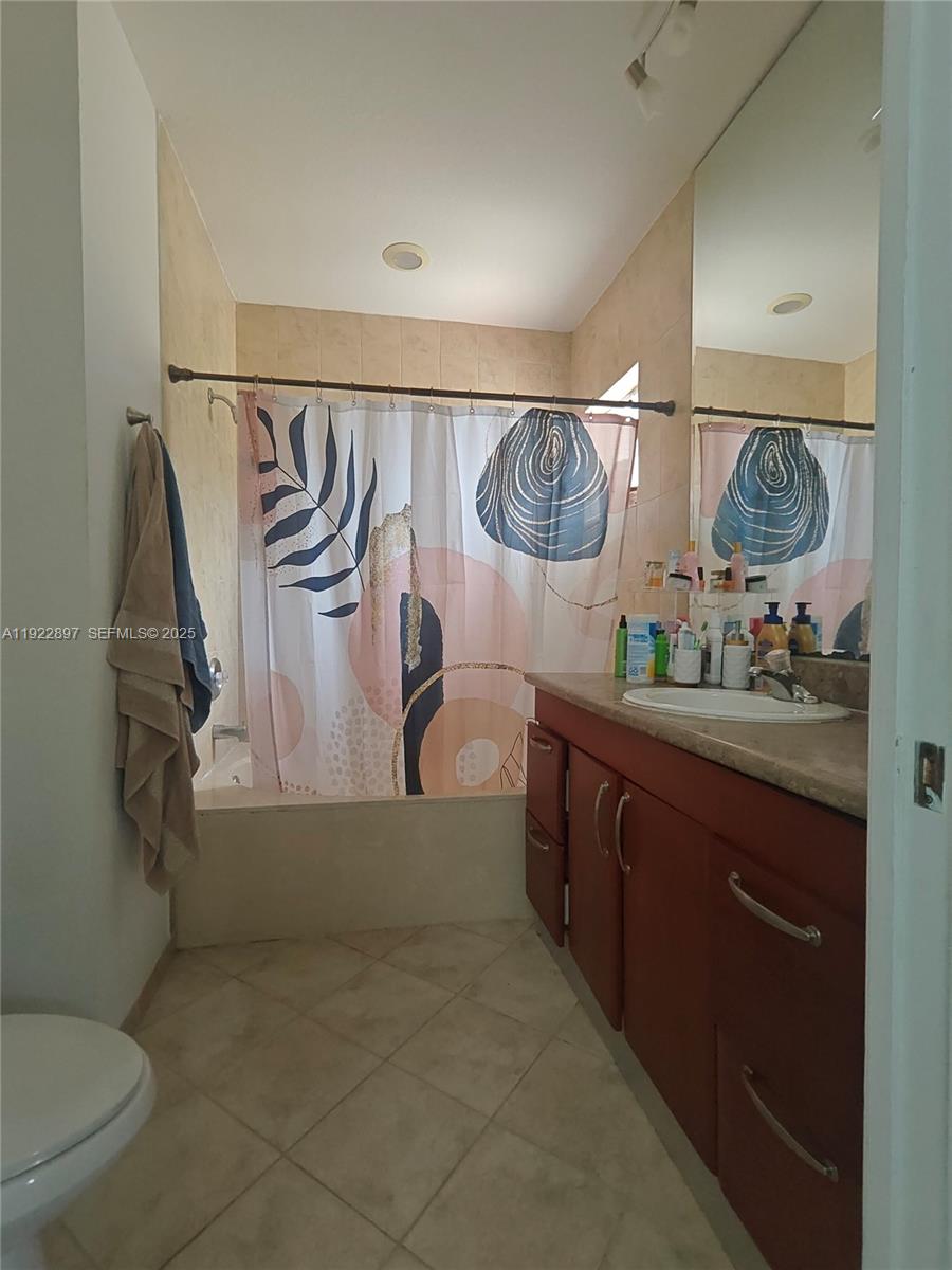 17847 Northwest 74th Path Hialeah, FL 33015 - Photo 25 of 35 a bathroom with a granite countertop sink a toilet and bathtub