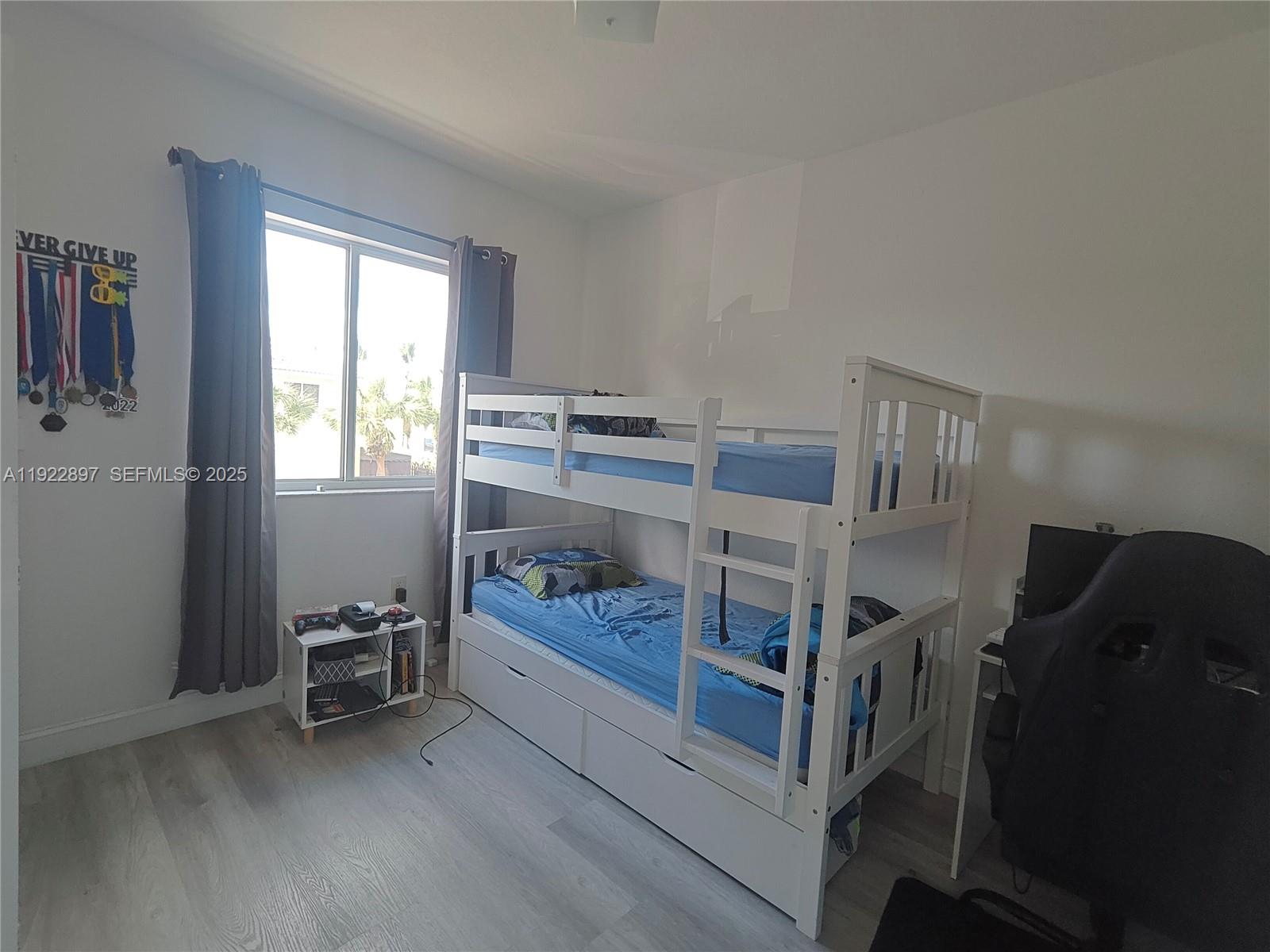 17847 Northwest 74th Path Hialeah, FL 33015 - Photo 27 of 35 a bedroom with furniture and a window