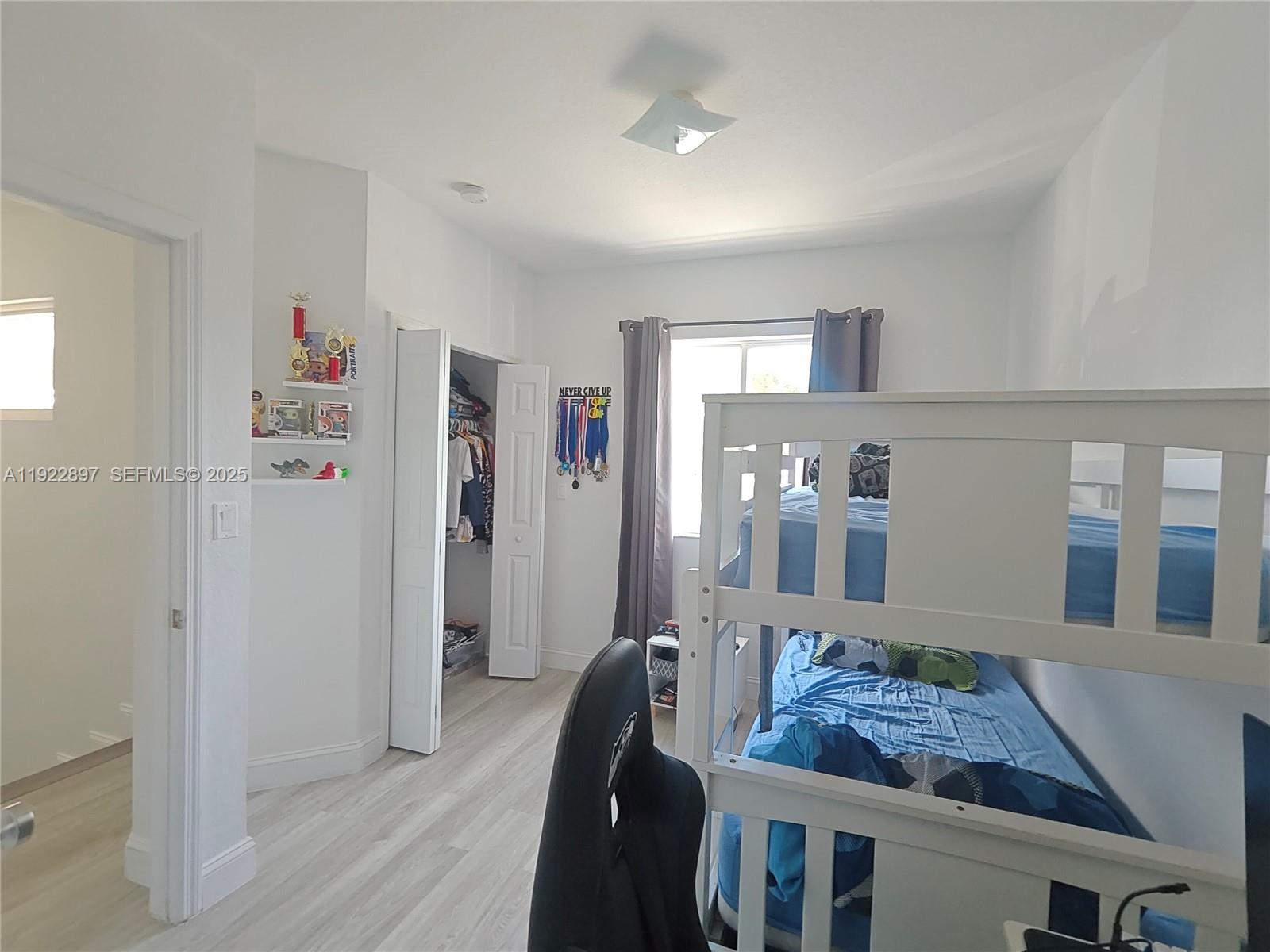 17847 Northwest 74th Path Hialeah, FL 33015 - Photo 29 of 35 a living room with furniture and a wooden floor