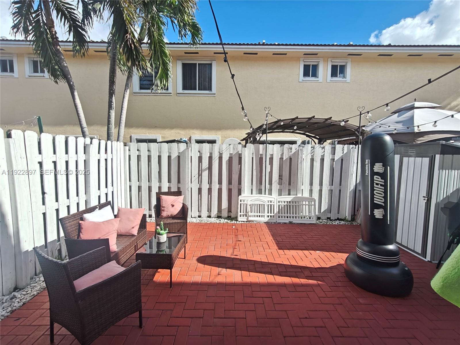 17847 Northwest 74th Path Hialeah, FL 33015 - Photo 30 of 35 a view of a patio with a table and chairs