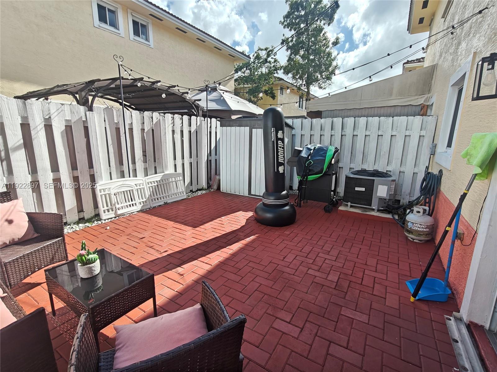 17847 Northwest 74th Path Hialeah, FL 33015 - Photo 32 of 35 a patio with table and chairs