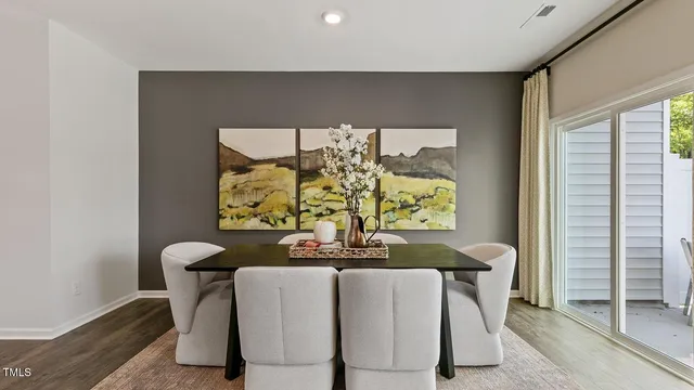 a view of a dining room with furniture and chandelier