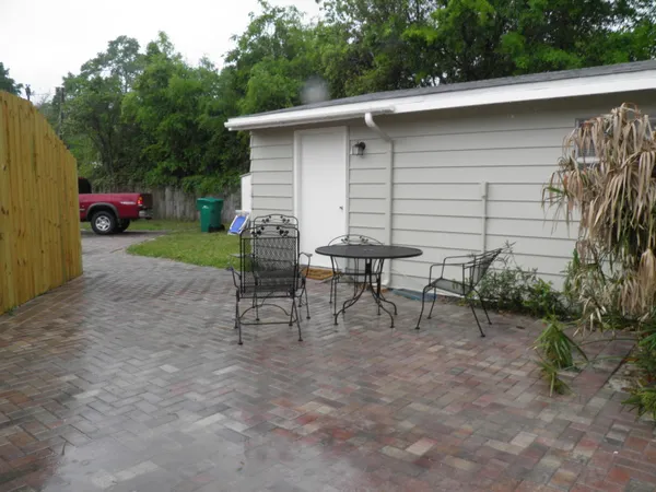 a view of backyard with outdoor seating and green space