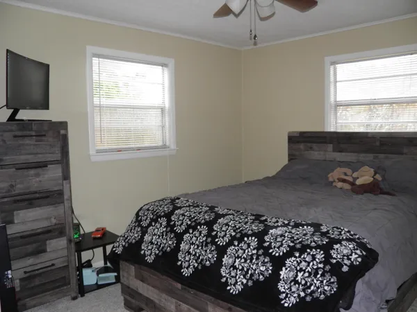 a bed sitting in a bedroom next to a window