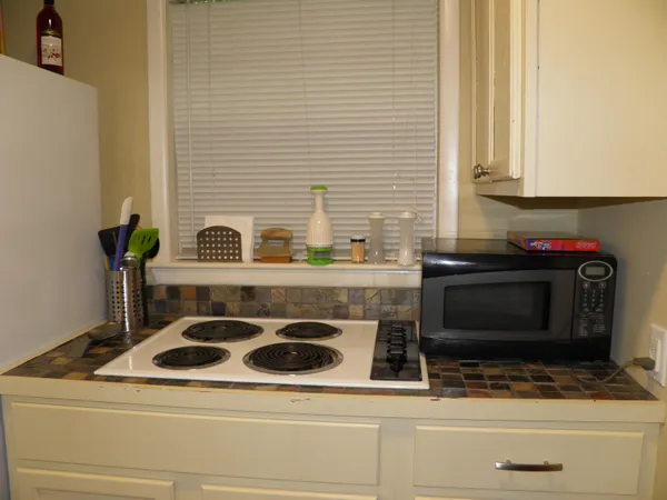 a stove top oven sitting inside of a kitchen