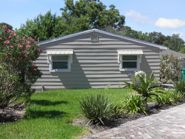 a front view of a house with garden