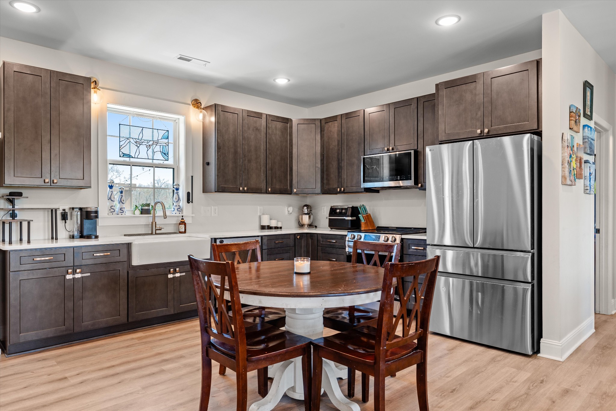 5195 Pleasant View Road Morrison, TN 37357 - Photo 14 of 45 a kitchen with stainless steel appliances wooden floors and wooden cabinets
