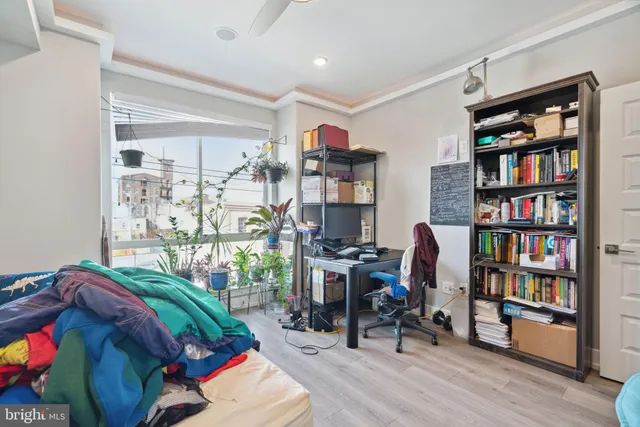 a living room with furniture and a book shelf