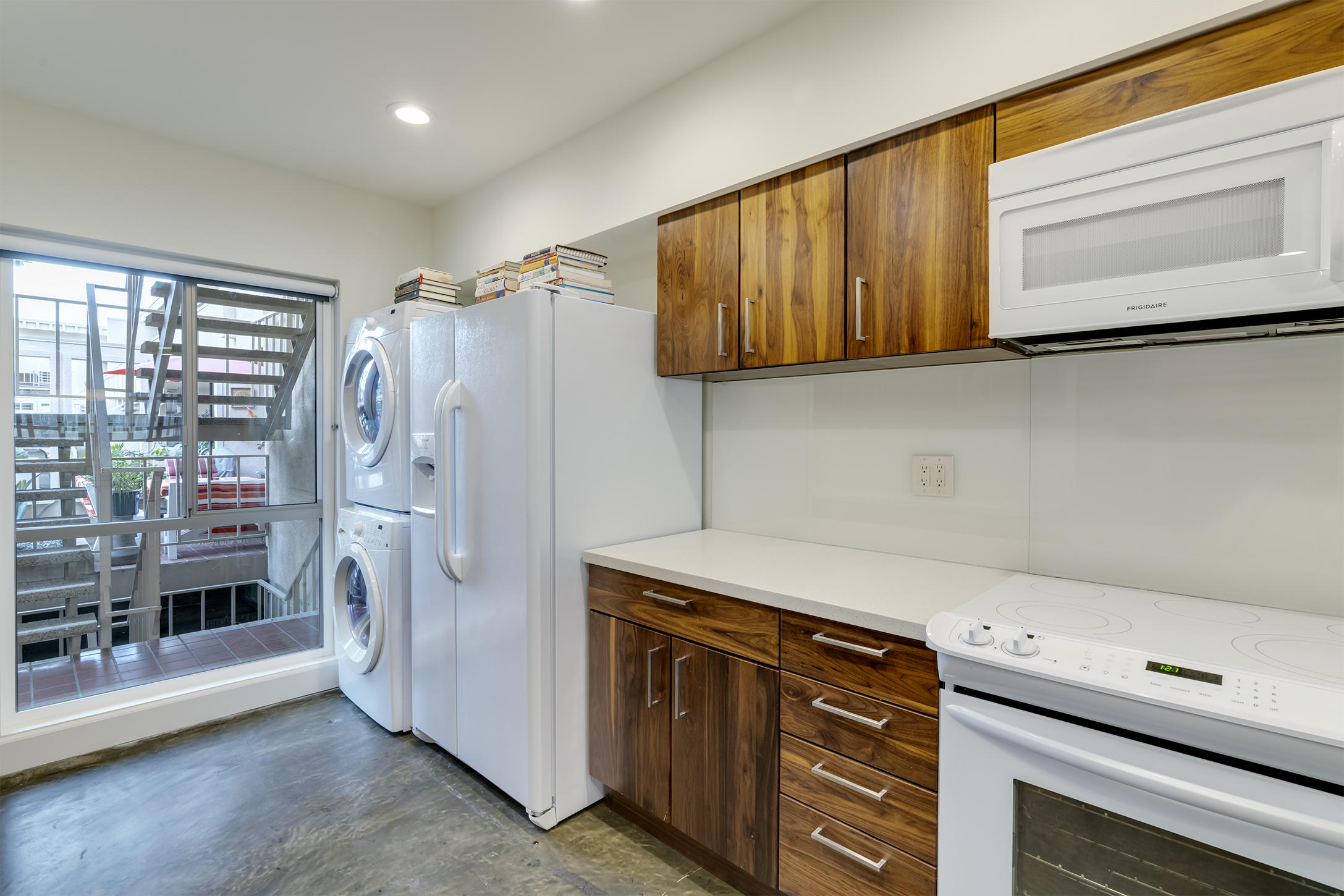 277 East Alejo Road, Unit 101 Palm Springs, CA 92262 - Photo 15 of 30 a kitchen with stainless steel appliances granite countertop a refrigerator and a stove