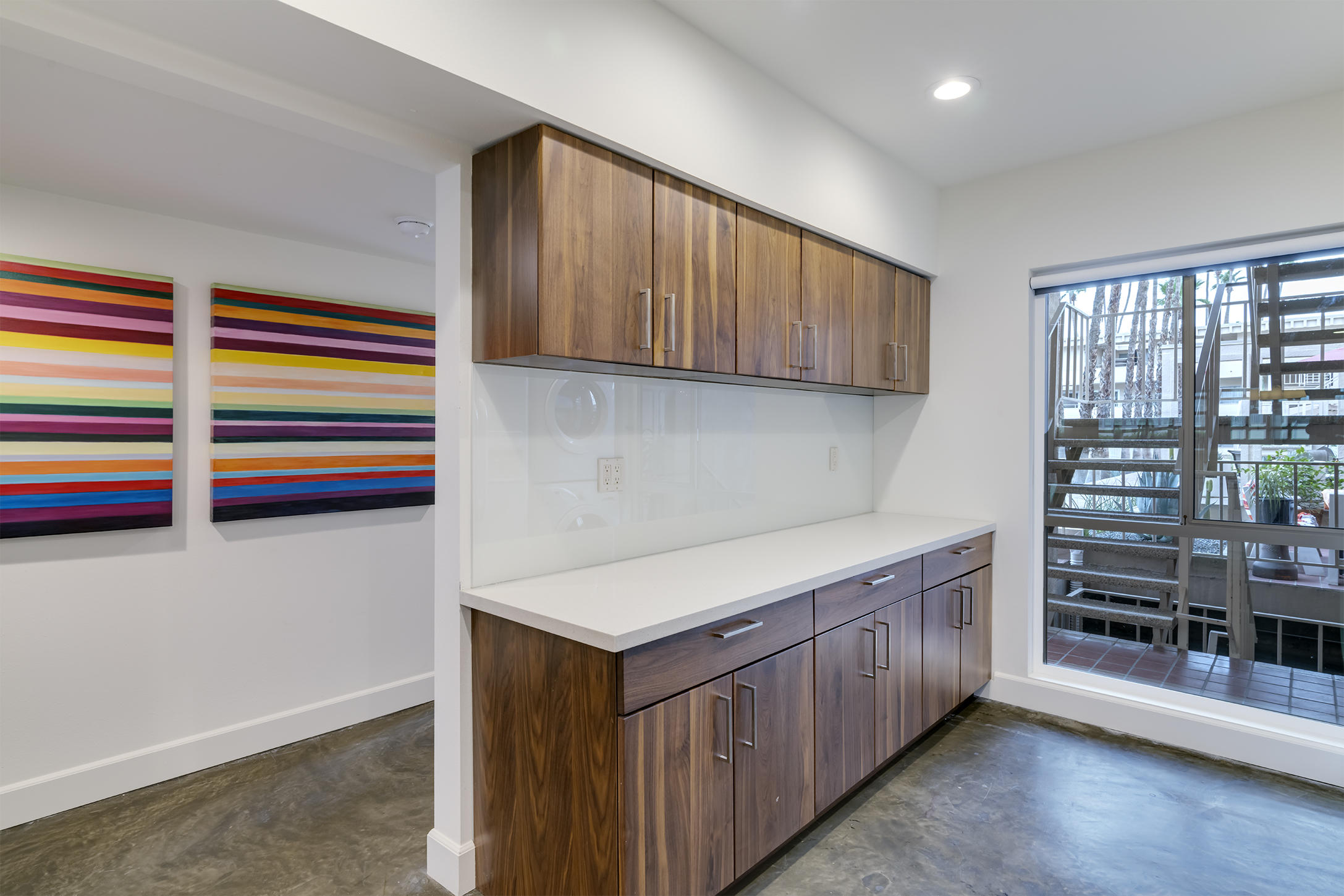 277 East Alejo Road, Unit 101 Palm Springs, CA 92262 - Photo 16 of 30 a kitchen with stainless steel appliances a refrigerator and wooden cabinets